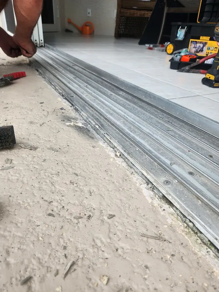 Sliding door track and threshold being replaced with new hardware in Naples, FL